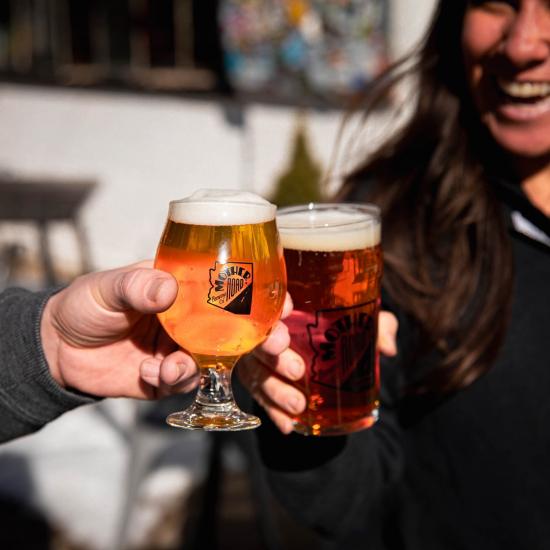 Friends toast with craft beers at a Flagstaff brewery